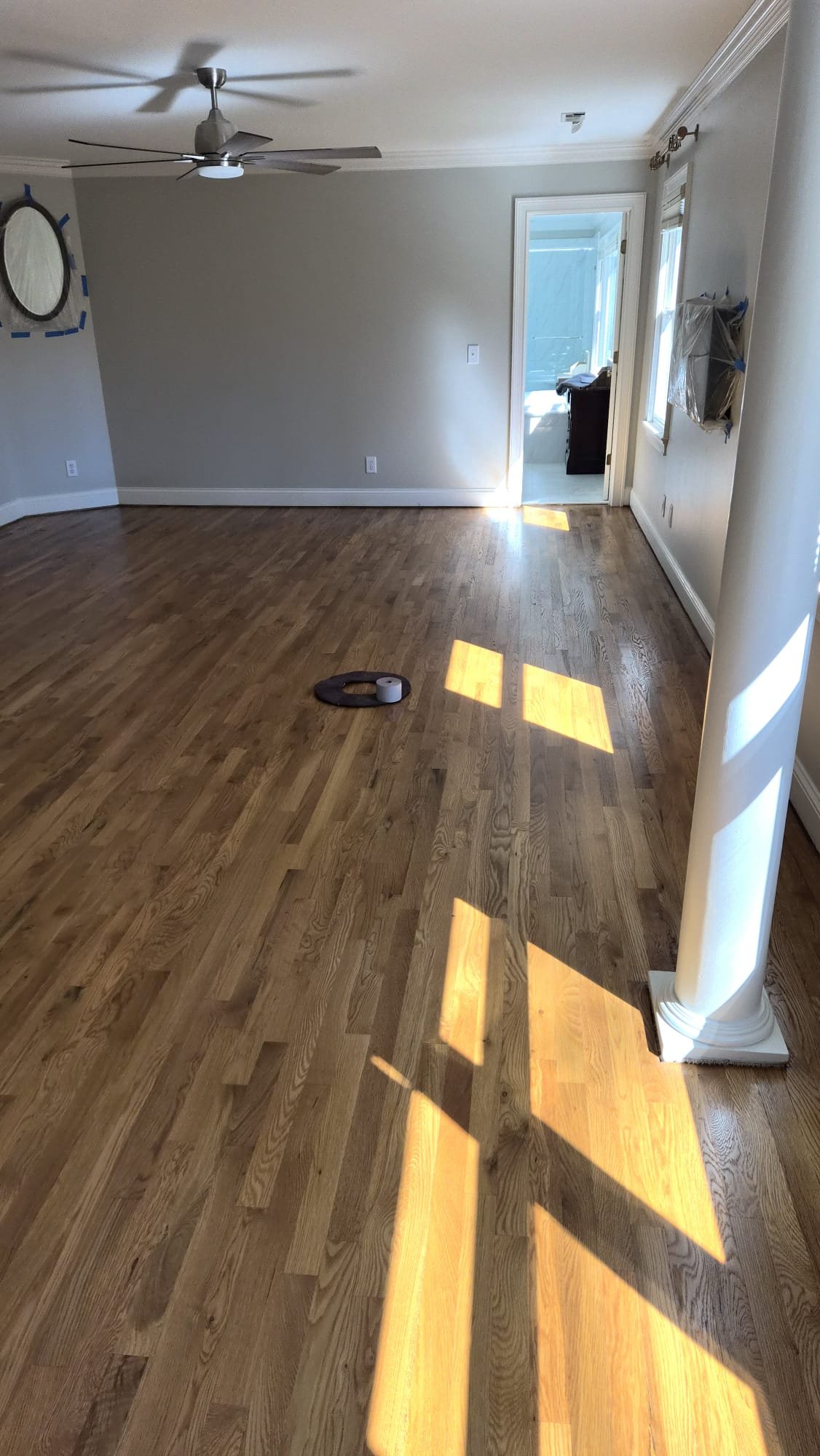 Refinished hardwood floor, sunlit room